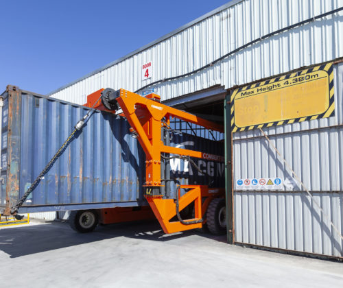 Straddle carrier operating in low doorway